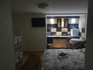 a small room with a bed and a kitchen at APARTMENT Marash 2 in Prizren +13 photos
