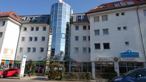 a tall building with a glass tower on top of it at Central Hotel Winnenden in Winnenden