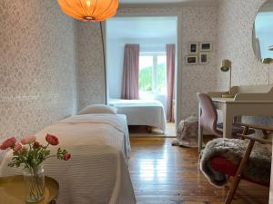 a bedroom with a bed and a table with a vase of flowers at Villa Fjellheim in Luster +46 photos