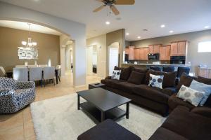 a living room with a couch and a table and a kitchen at Simply Irresistible in Phoenix