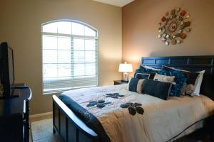 a bedroom with a large bed and a window at Simply Irresistible in Phoenix