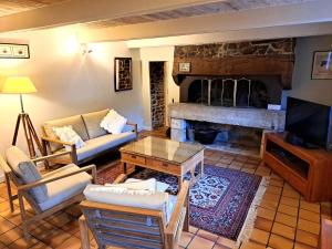 a living room with a couch and a fireplace at Ty Papy in Bénodet
