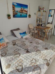 a large bed in a room with a table at One minute to the beach in Becici +6 photos