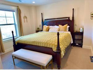 a bedroom with a large bed with a yellow comforter at Ski Haven Hideaway 15 Mins to Park City Slopes in Keetley Junction