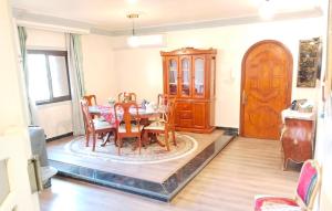 a dining room with a table and a wooden cabinet at 2 Bedrooms Spacious flat 7 mins to Airport in Cairo