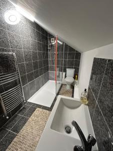 a bathroom with a sink and a shower and a toilet at Lovely 2 bed house in Hawkshead in Hawkshead +13 photos