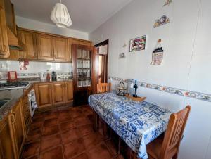 a kitchen with a table in the middle of it at SW Beach House Zambujeira do Mar in Zambujeira do Mar