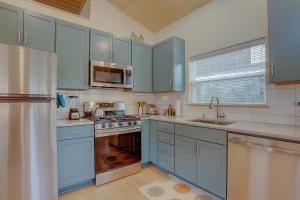 a kitchen with blue cabinets and a sink at Mod Pod in Bend