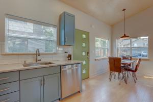 a kitchen with a sink and a table with chairs at Mod Pod in Bend