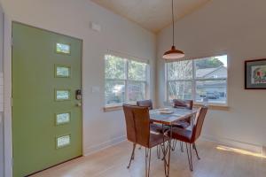 a dining room with a table and chairs and a green door at Mod Pod in Bend +14 photos