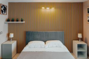 A bed or beds in a room at Catanese Proverb's House - Via Napoli - Ground Floor