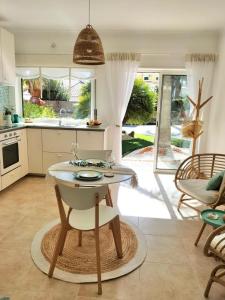 a kitchen with a table and chairs in a room at Casa Mós in Lagos