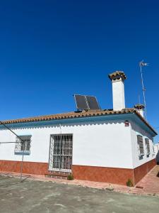 a white building with solar panels on the roof at Chalet Grande Margarita, 75 in El Puerto de Santa María