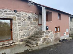 a stone house with stairs in front of it at Casa Morgade in Montalegre