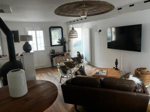 a living room with a couch and a table at Maison Chez ACHILLE in Évreux
