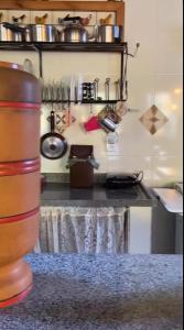 a kitchen with a table and a counter with pots and pans at Calmaria in Vila Velha