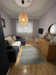 a living room with a couch and a table at Comfy Cardiff Bay Budget Stay with Small Garden 15 mins Walk to Cardiff Bay in Cardiff