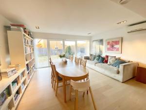a living room with a table and a couch at Villa Kristiania in Oslo +26 photos