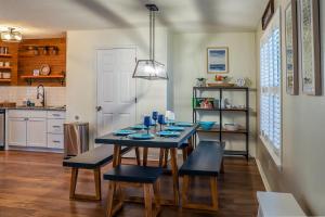 a dining room with a table and chairs and a kitchen at Pool House, Short Drive to Beach, Grill, Smart TV in Navarre