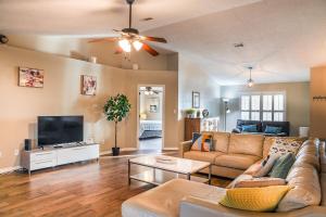 a living room with a couch and a flat screen tv at Pool House, Short Drive to Beach, Grill, Smart TV in Navarre