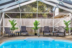 a group of chairs and a swimming pool at Pool House, Short Drive to Beach, Grill, Smart TV in Navarre