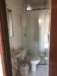 a bathroom with a toilet and a sink at Apto de tuco in Ilhéus
