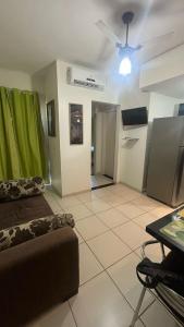 a living room with a couch and a table at Flat Village - Aldeia das Águas D301 in Barra do Piraí +16 photos