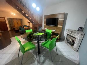 a living room with a table and green chairs at Host Patagonia - DPX in Plaza Huincul