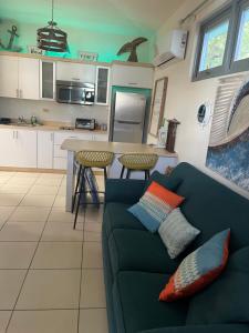 a living room with a couch and a kitchen at MY DREAM BEACH HOUSE in Aguada