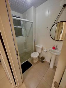 a bathroom with a shower and a toilet and a sink at Ap 50m do Mar, no Coração da Praia de Fora in Palhoça