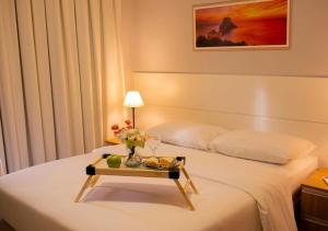 En eller flere senge i et værelse på Apto Ibiza Praia & Piscina - Conforto e Estilo