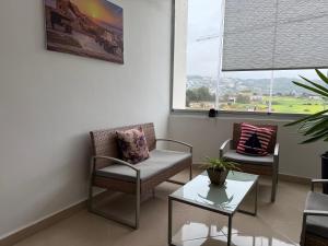 a waiting room with chairs and a table and a window at The Paradise of ACHAKAR in Tangier +17 photos