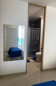 a room with a bathroom with a bed and a toilet at Condominio Reserva del mar Santa Marta in Gaira