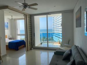 a bedroom with a bed and a view of the ocean at Condominio Reserva del mar Santa Marta in Gaira +32 photos
