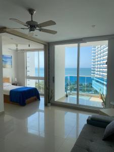 a bedroom with a bed and a view of the ocean at Condominio Reserva del mar Santa Marta in Gaira