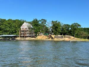 a house on an island in the middle of the water at Hidden Valley Paradise Luxurious Lakefront Retreat in Eldon