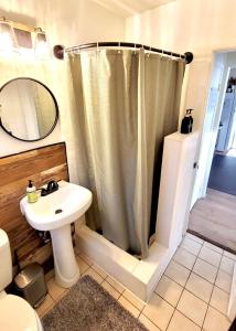 a bathroom with a shower curtain and a sink at Beach Bungalow By The Sea 1 in Cocoa Beach