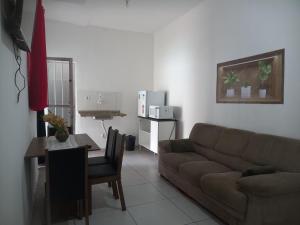 a living room with a couch and a table at Jardim Paraíso in Duque de Caxias