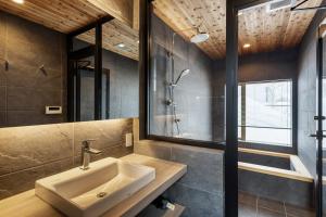 a bathroom with a sink and a shower at Aoyama Lodge 2 in Kutchan +26 photos
