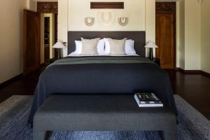 a bedroom with a large bed with a book on it at Villa Aman - Tropical Luxury with Infinity Pool in Port Douglas