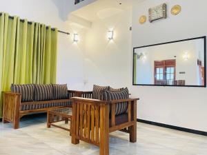 a living room with two couches and a mirror at Villa 10 Weligama in Weligama
