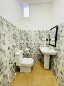 a bathroom with a toilet and a sink at Villa 10 Weligama in Weligama +36 photos