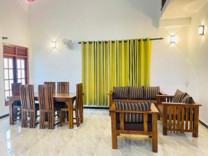 a dining room with a table and chairs at Villa 10 Weligama in Weligama