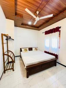 a bedroom with a bed and a wooden ceiling at Villa 10 Weligama in Weligama