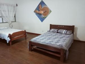 a bedroom with a bed and a small bed sidx sidx sidx at Casa Verde in Quillabamba +13 photos