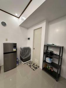 a kitchen with a refrigerator and a door in a room at Lantern Villa in Calulut +12 photos