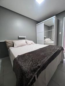 a bedroom with a large bed with a large mirror at Apartamento para COP30 com vista para a baía in Belém +26 photos