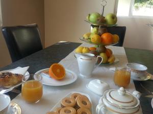 a table with a breakfast of fruit and orange juice at Dubrovnik Residence Nodilo in Dubrovnik