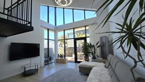 a living room with a couch and a flat screen tv at Jeju Jebistay in Seogwipo
