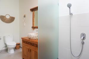 a bathroom with a shower and a toilet at Ayunan Beach Villas Amed in Amed +30 photos